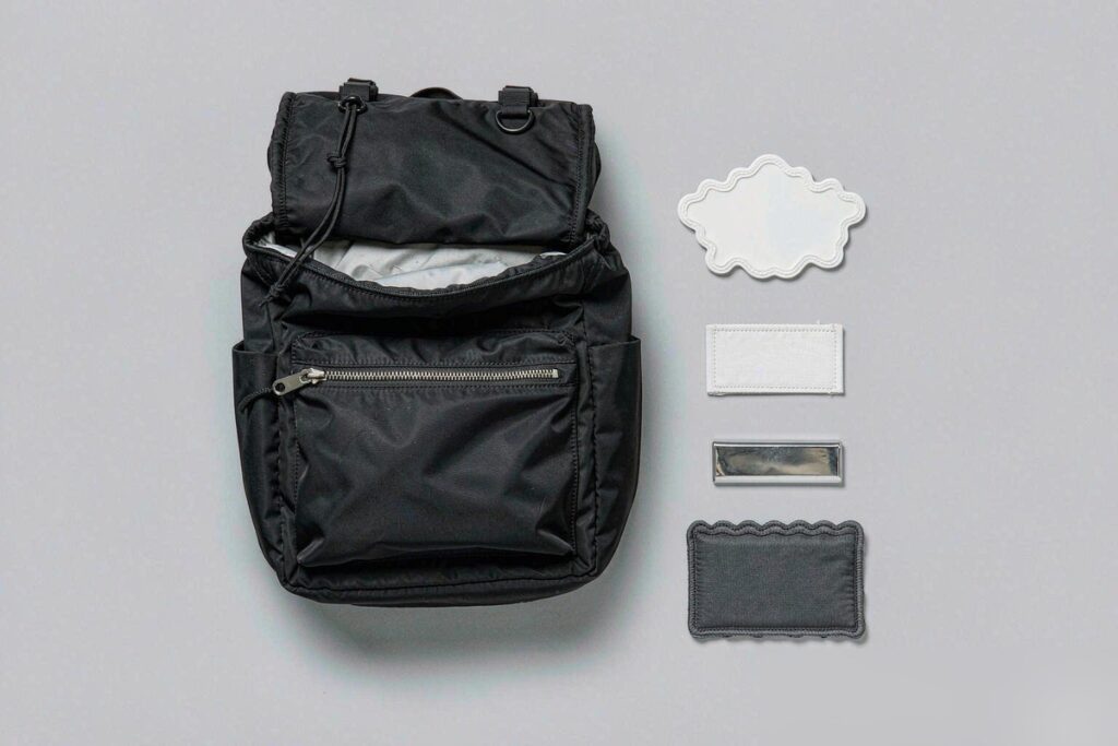 Custom logo options for bags: embroidered patch, metal plate, woven label, silicone patch