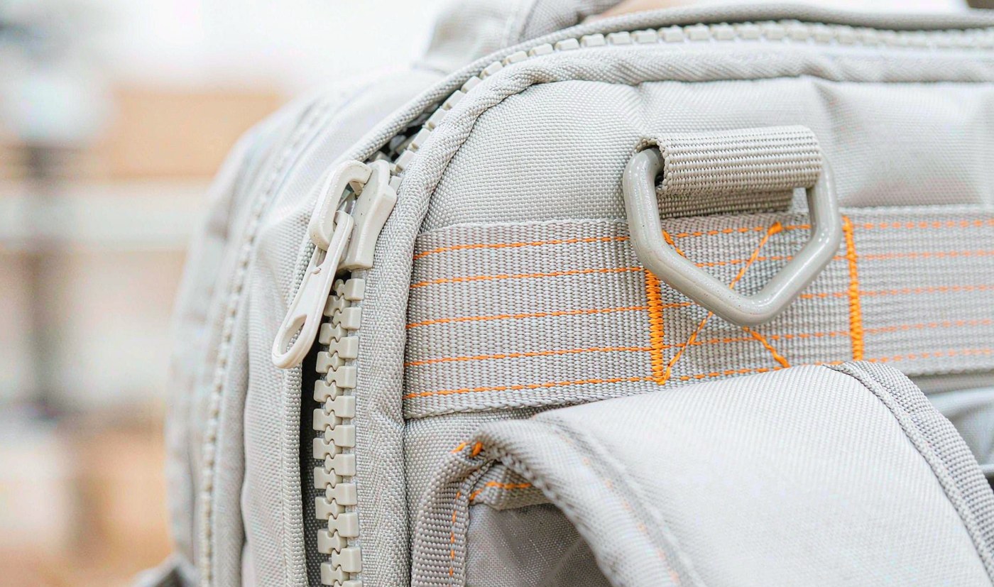 YKK zipper, webbing lock-stitch sewing and metal hardware detail on Kovoeky nylon bag